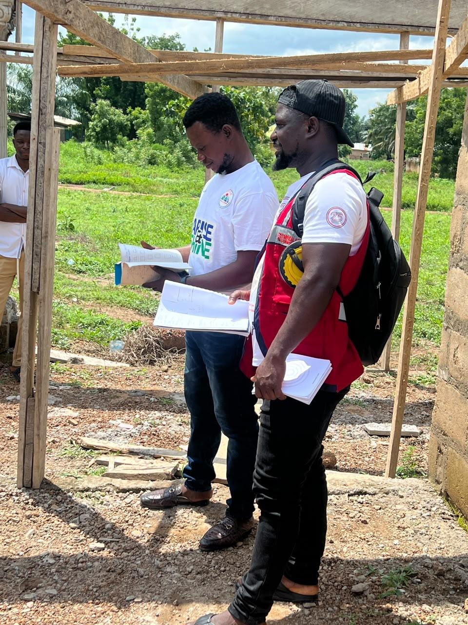 Team members reviewing the building drawings on site
